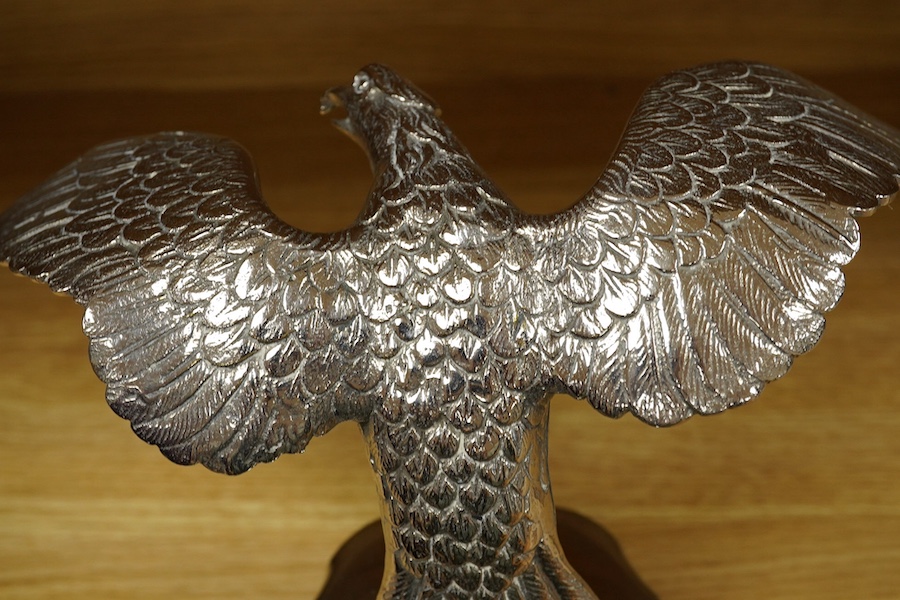 A large chromed eagle car mascot, mounted on a large radiator cap and turned socle, height 21.5cm. Condition - good.